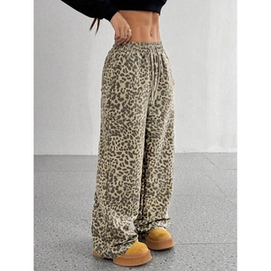 Detail showing the drawstring elastic waistband and leopard print pattern on wide leg pants