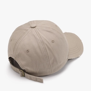 Distressed khaki cotton baseball cap with adjustable metal buckle on back profile view