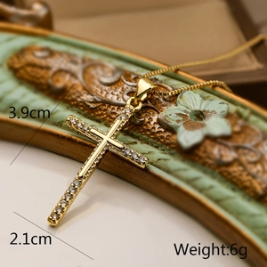 Close-up of 18K gold plated cross pendant with zircon stones and dimensions 3.9x2.1cm