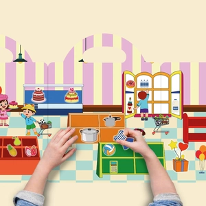 Close-up of a child interacting with a colorful reusable supermarket scene sticker book