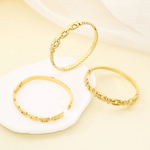 Detail view of 18K gold plated stainless steel hollow square bangle with pavé crystals