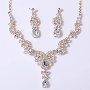 Detailed top view of luxury gold bridal jewelry set with sparkling crystal teardrop charms