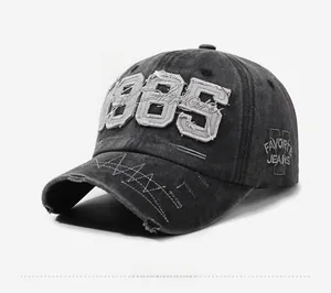 Detail of vintage washed grey baseball cap with 1985 patch and distressed brim texture