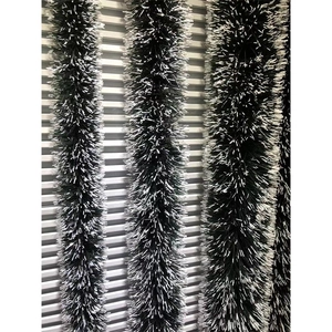 Green Christmas tinsel garland with white tips for holiday party decorations