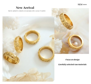 Detailed close-up of vintage gold sun and moon ring with relief patterns and zircons