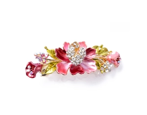 Detail of vintage butterfly hair clip with red enamel flowers and sparkling rhinestones