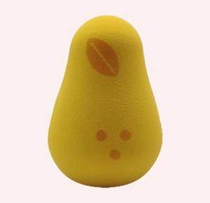 Close-up of a pear-shaped yellow makeup sponge with orange leaf detail and soft texture