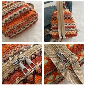 Detail of woven ethnic backpack showing metal zippers and zigzag wave pattern fabric