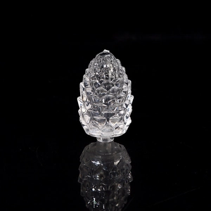 Macro shot of a clear crystal pinecone light accessory with sharp faceted detailing