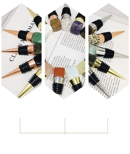 Close-up of crystal wine stoppers with natural raw stones and metal sealing rings