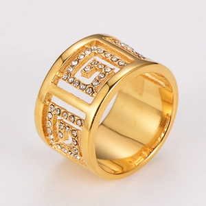 Macro view of gold-plated wide ring with hollow Greek key pattern and micro-inlaid rhinestones