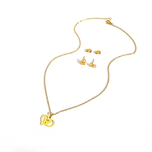Detailed view of golden stainless steel heart jewelry set with butterfly pendant