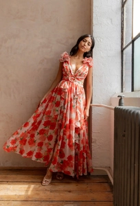 Close-up of floral V-neck maxi dress with waist cut-outs and decorative ring details