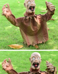 Macro view of scary zombie lawn stake prop with tattered brown clothes and bulging eyes