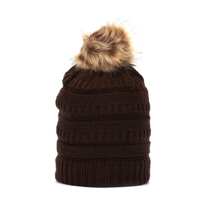 Close-up of the thick knit texture and fluffy faux fur pompom on this winter beanie