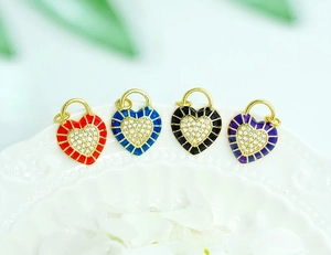 Macro detail of heart lock pendants with colorful enamel and micro-pave zirconia in 18K gold