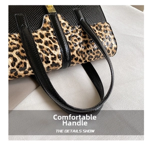 Close-up of leopard print and black lizard texture leather with golden clasp detail