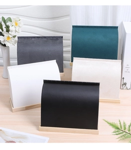 Detailed view of necklace display stands in velvet and microfiber with wood bases