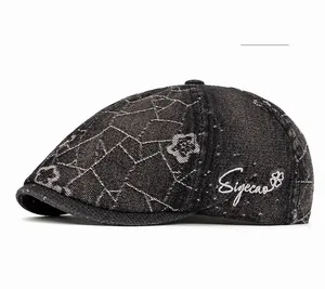 Close-up of vintage dark grey denim beret with white floral patterns and Siyecao logo