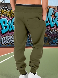 Men's olive green jogger detail featuring a back pocket and elastic ribbed cuffs