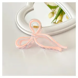 Pink bow shark hair claw clip in jelly acrylic finish measuring 11cm for thick hair