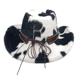 Detail of cow print western hat featuring turquoise beads and brown leather band