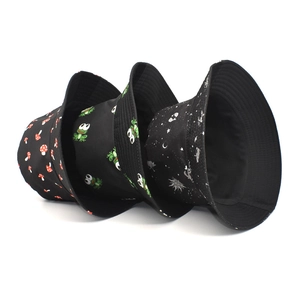 Three cotton bucket hats set with mushroom, frog, and galaxy prints on black fabric