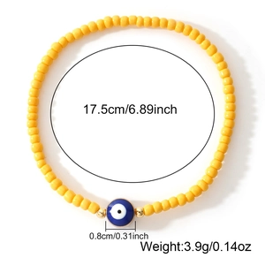 Bohemian yellow beaded evil eye bracelet with golden spacers and 17.5cm elastic band