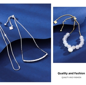 Detail of S925 sterling silver box chain and gold bead bracelet with adjustable sliders