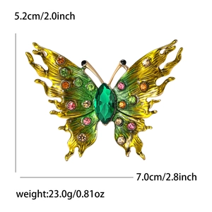 Elegant butterfly brooch in gold alloy with colorful crystals and enamel wings