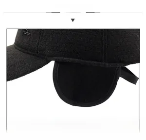 Close-up of black wool baseball cap featuring thick ear flaps for winter warmth