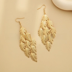 Detailed view of 18k gold plated multi-layer feather tassel earrings with brushed texture