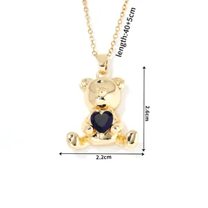 Detail view of gold bear pendant with blue heart crystal and precise size measurements