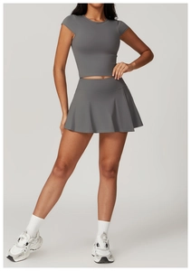 Detail of dark grey high-waist pleated tennis skirt and slim fit short sleeve top