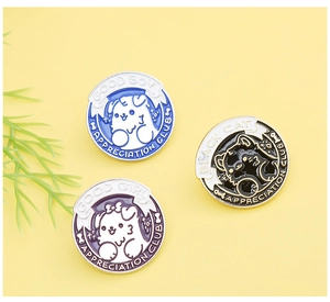Detailed view of enamel animal pins featuring Good Boy, Good Girl, and Black Cat designs