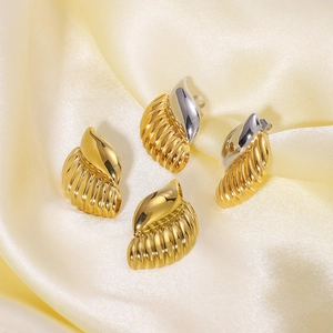 Minimalist spiral conch stainless steel studs in gold and silver finish on silk