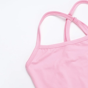 Detail of pink knitted camisole showing elastic fabric texture and cross strap design