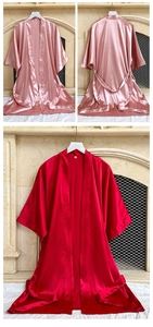 Detail view of satin silk robes with waist ties in red and pink colors for women