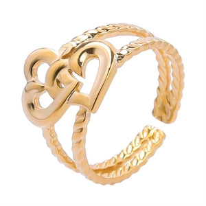 Detailed macro of golden double heart ring with adjustable double twisted rope band