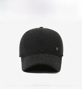 Front view of charcoal grey tweed baseball cap for men with a silver shield emblem