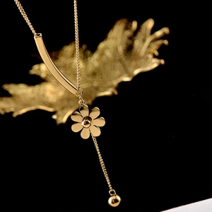 Elegant gold Y-shaped necklace with sun flower pendant and polished metal bar detail