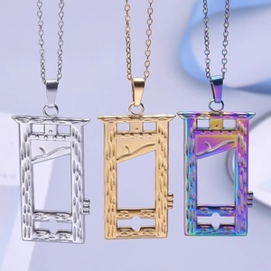 Detail of guillotine pendant necklaces in gold, silver, and rainbow stainless steel