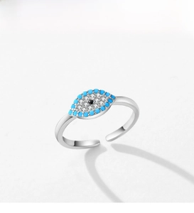 Macro detail of silver evil eye ring featuring turquoise blue stone and cubic zirconia