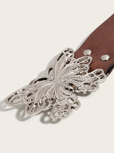 Close-up of brown leather belt featuring an intricate silver butterfly buckle and metal studs