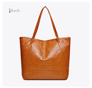 Detailed back view of vintage crocodile pattern tote bag with slender dark brown handles