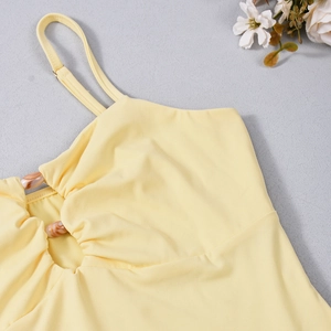 Detail of yellow camisole featuring hollow-out cut and marble texture ring buckle
