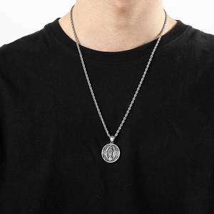 Close-up of silver Saint Mary medallion with twist rope chain on model's neck