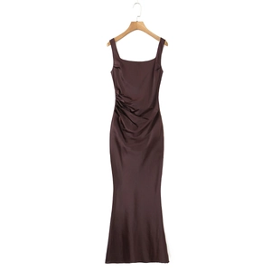 Detailed view of chocolate satin dress featuring asymmetric waist pleats and square neckline