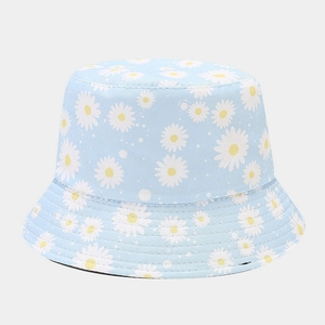 Close-up of small daisy floral print on light blue cotton canvas bucket sun hat