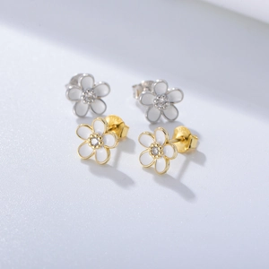 Detailed macro view of S925 silver daisy stud earrings with white enamel and tiny zircon